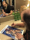 Steve Earle signing fine art prints by artist Robert Hurst